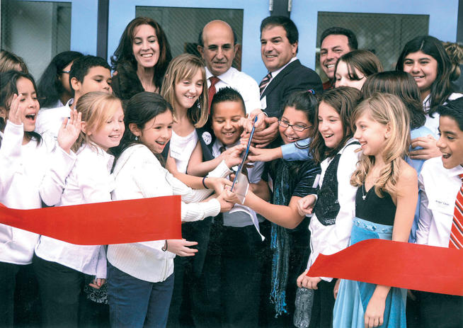 Klein participates in a ribbon-cutting ceremony at the opening of a school in Middle Village, Queens, in 2010. PHOTO: COURTESY JOEL KLEIN ’67